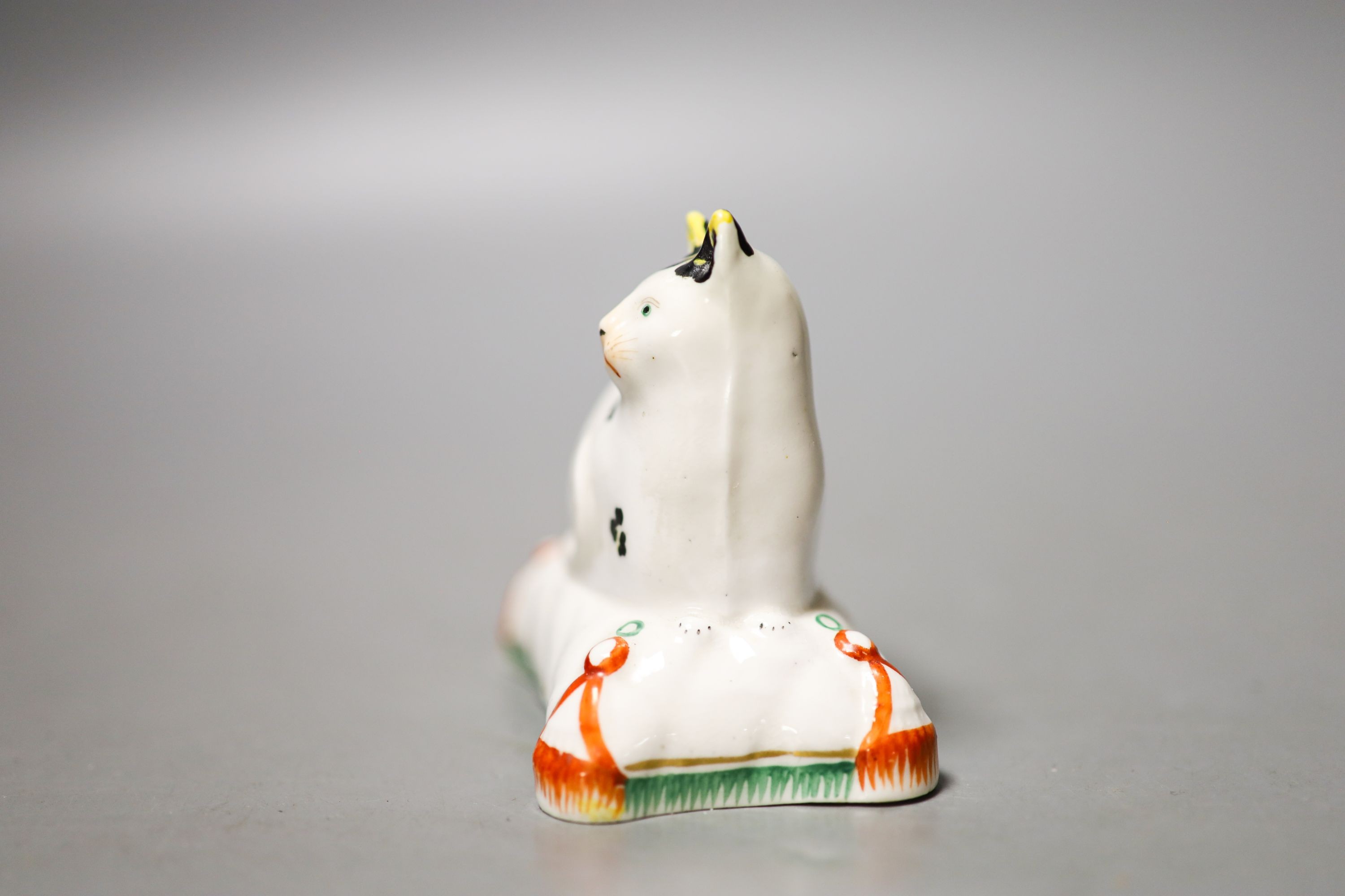 A Staffordshire porcelain model of a cat seated on a cushion, c.1835–50